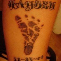 Text with footstep and date tattoo