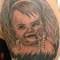 Child with wings tattoo