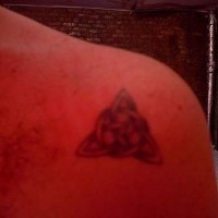 Trifolium symbol tattoo on shoulder