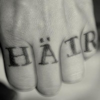 Knuckle tattoo, hair, german black inscription