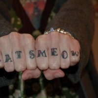Knuckle tattoo, cats meow, designed inscription