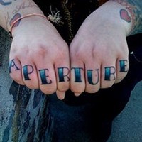 Knuckle tattoo, aperture, black and blue designed