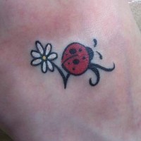 Ladybug on daisy flower tattoo