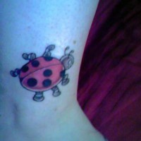 Cartoonish ladybug  tattoo on ankle