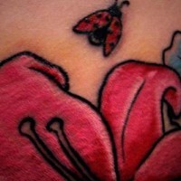 Ladybug on pink flower tattoo