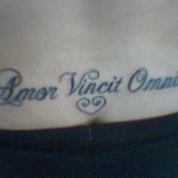 Amor vincit omnia lower back tattoo