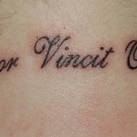 Amor vincit omnia lettering tattoo