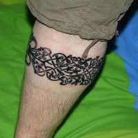 Leg tattoo,black  band of splitted little flowers