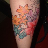 Leg tattoo, many colourful different flowers