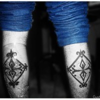 Leg tattoo, two black designed  rhombs