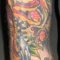 Leg tattoo, skull masked between rose and candle