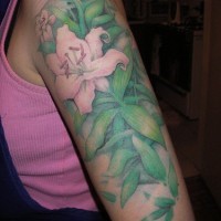 Lily flowers in greens arm tattoo