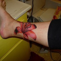 fiore rosso femminile sulla gamba tatuaggio