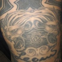 Symmetrical lion heads tattoo