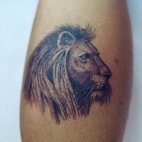 Lion head black ink tattoo on forearm