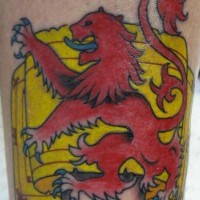 El tatuaje heraldico de un leon rojo con la lengua azul sobre una bandera amarilla