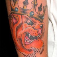 Cartoonish lion in crown tattoo