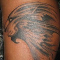 Lion profile black ink tattoo