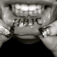 Lip tattoo, hbic with dots, big bold letters