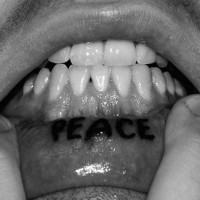 Lip tattoo, peace, bold, black inscription