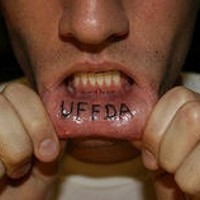 Lip tattoo, uff da, black meaningful inscription