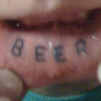 Lip tattoo, beer, simple styled inscription