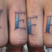 Knuckle tattoo, live free, blue styled inscription