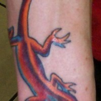 El tatuaje de una lagartija de colores en el brazo