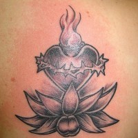 el tatuaje de una flor de loto con el corazon sagrado hecho en color negro