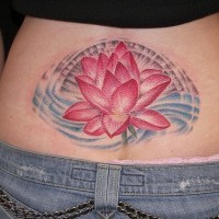 Large red lotus tattoo on lower back