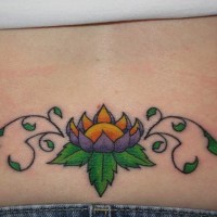 Purple lotus tracery tattoo on lower back