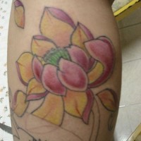 Lotus flower with falling petals tattoo