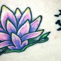 el tatuaje de una flor de loto morada con un jeroglifico