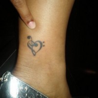 Treble clef heart tattoo on leg