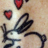 Rabbit with red hearts tattoo