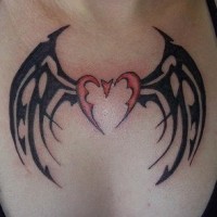 Tribal heart with bat wings tattoo