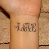 Ev Love word tattoo on wrist