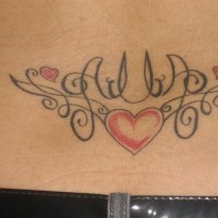 Symmetrical heart tracery tattoo on lower back