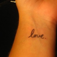 Small love writing tattoo on wrist