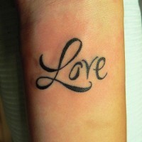 Elegant love lettering wrist tattoo
