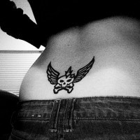 Lower back tattoo, black, bold, styled skull with wings