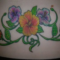 Lower back tattoo, picturesque, big, yellow and violet flowers
