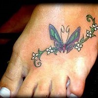 Butterfly on white flowers foot tattoo