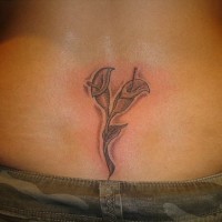 Lower back tattoo, two crossed, connected flowers