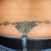 Lower back tattoo, big, blue letter, style, flowers