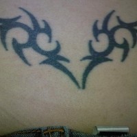 Lower back tattoo, decorated black wings