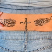Lower back tattoocrossed inscriptions, wings
