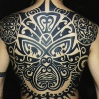 Whole back tattoo of maori tribal face