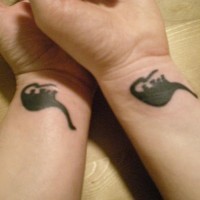 Matching dinosaur friendship tattoo on wrist