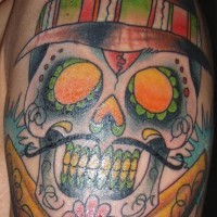 Sugar skull in hat with cannons coloured tattoo